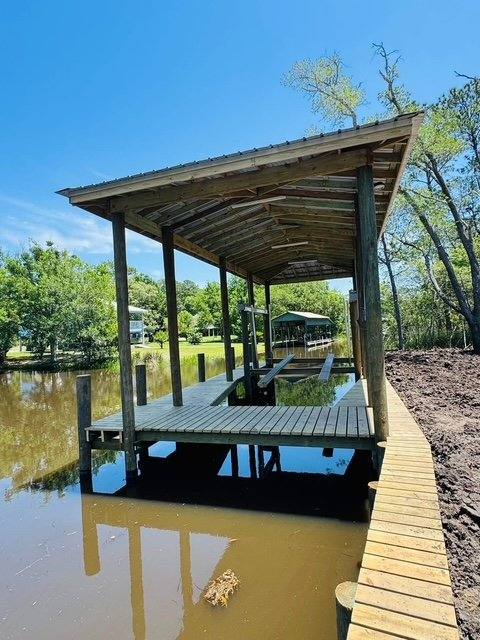 Boathouse and catwalk on a tree-lined river