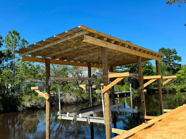 Boathouse frame with lift cradles over the water