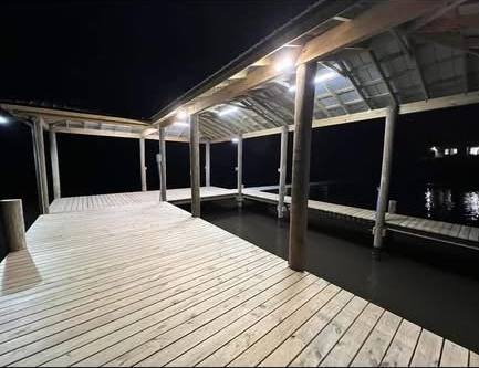 Lights on under a boathouse roof at night